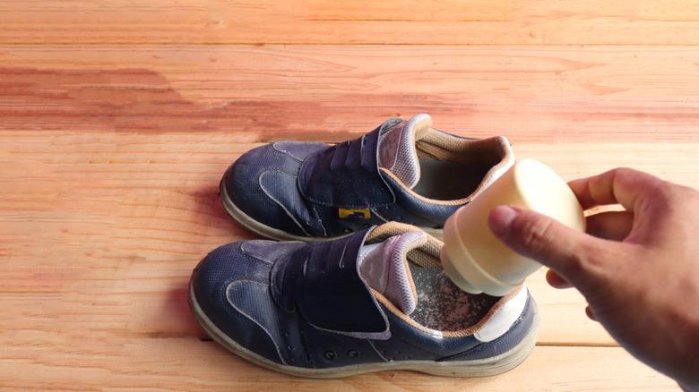 Sprinkling baby powder into shoes