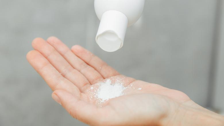 Sprinkling baby powder onto hands