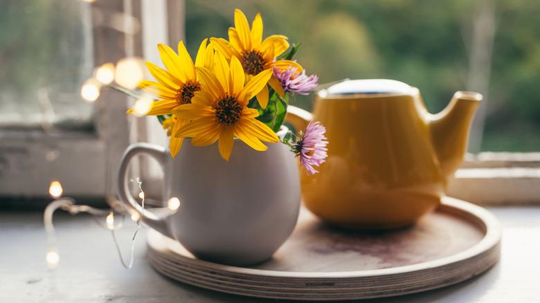 Bright spring blossoms tucked into white coffee mug