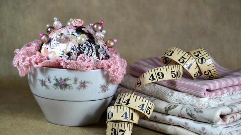Pin cushion nestled in coffee cup