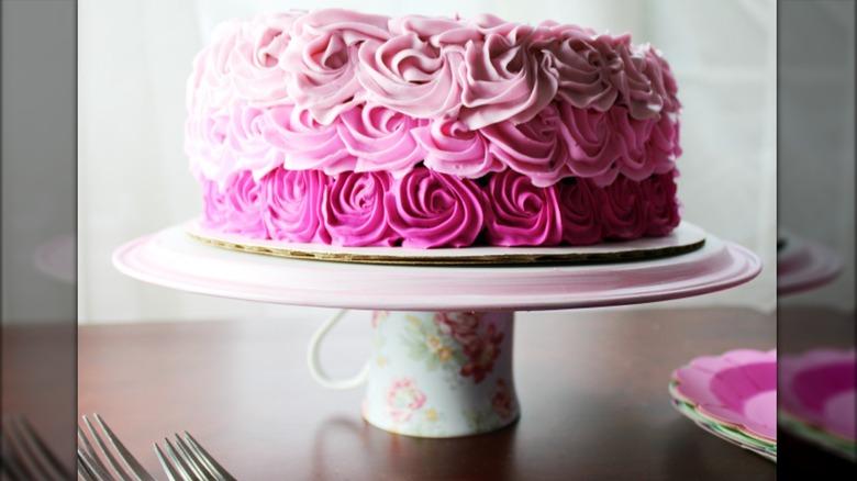 Cake stand made from floral coffee cup glued to cake platter