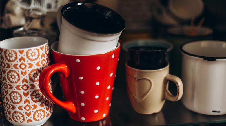 Stack of mismatched coffee cups