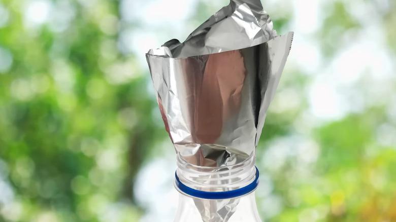 Makeshift funnel made from aluminum foil