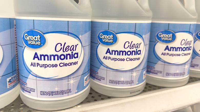 Bottles of ammonia all purpose cleaner sitting on a store shelf.