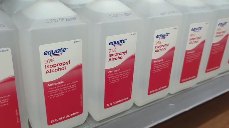 Bottles of diluted isopropyl alcohol (rubbing alcohol) sitting on a shelf).