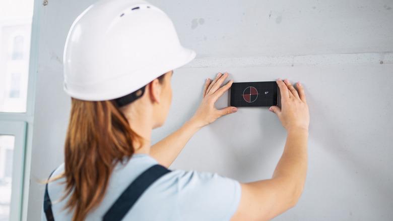 Builder using stud finder while renovating a house