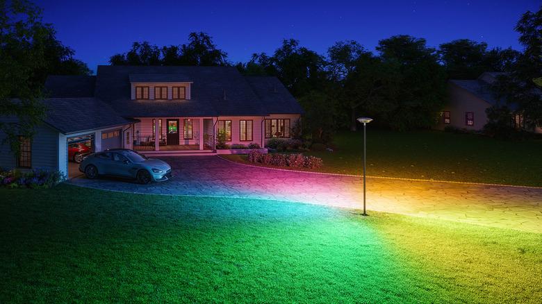 front yard illuminated with the Govee Outdoor Lamp Post Light in its signature petal-shaped rainbow design