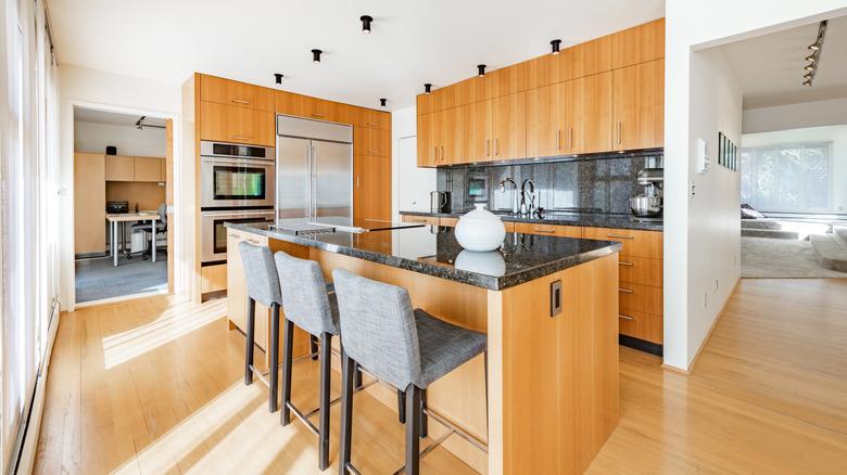 A modern kitchen with natural wood slab cabinets