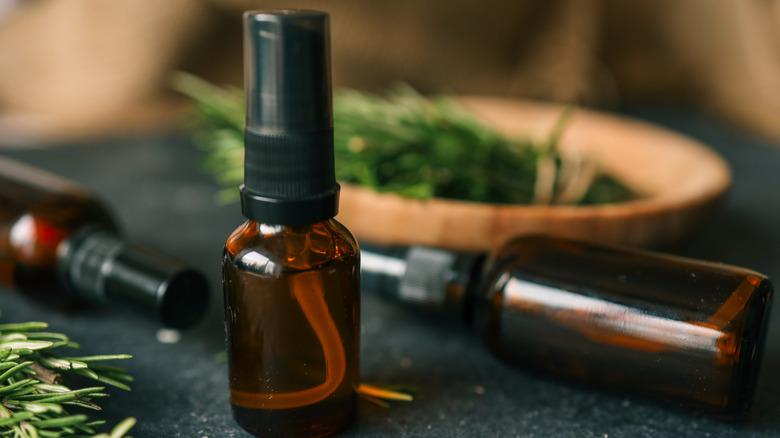 Person making a rosemary oil preparation from fresh rosemary sprigs