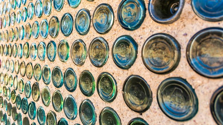 cob wall with glass bottles