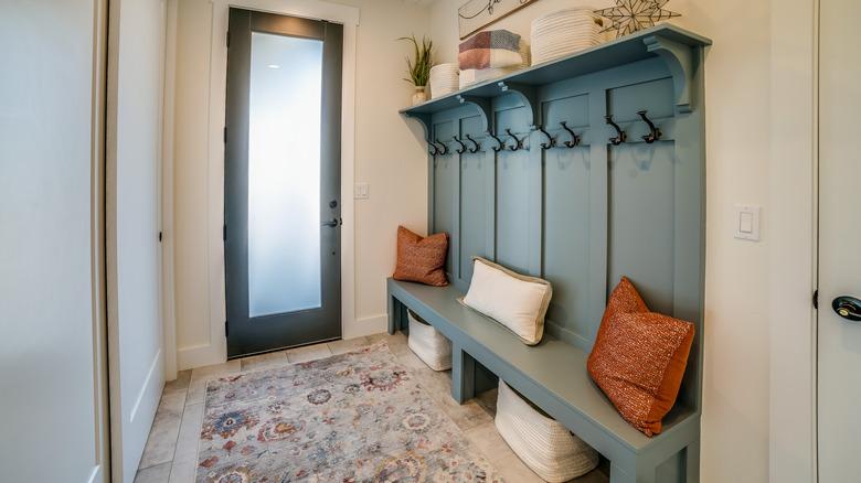 narrow home front entryway with bench
