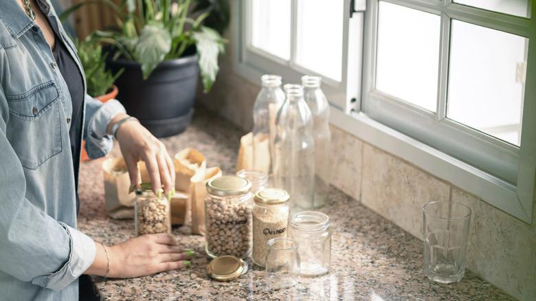 woman reusing glass jars for storage