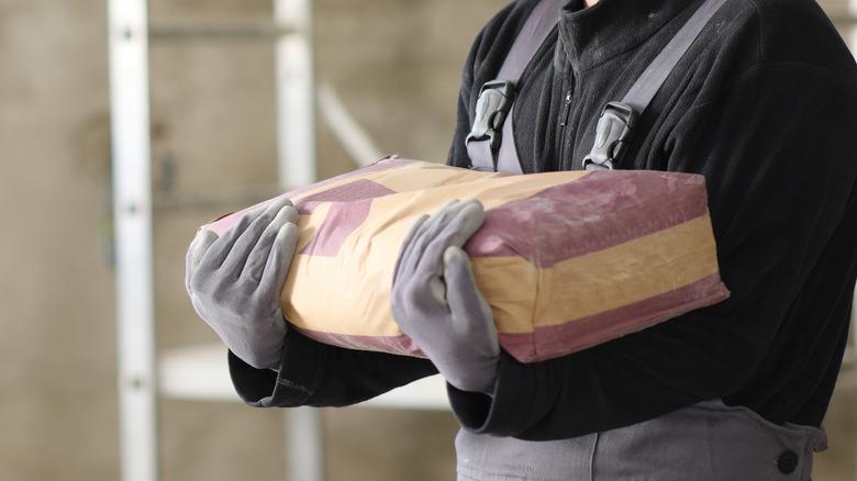 Man holding bag of cement