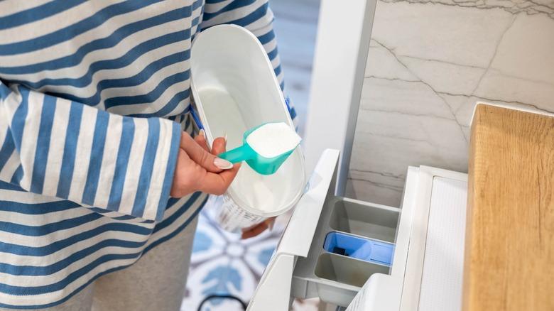 woman loading washer with powder