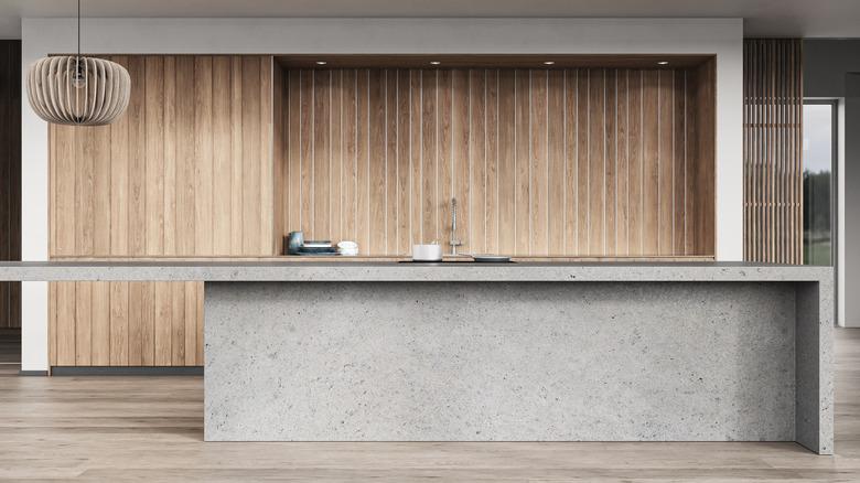a concrete kitchen island in a minimalist kitchen