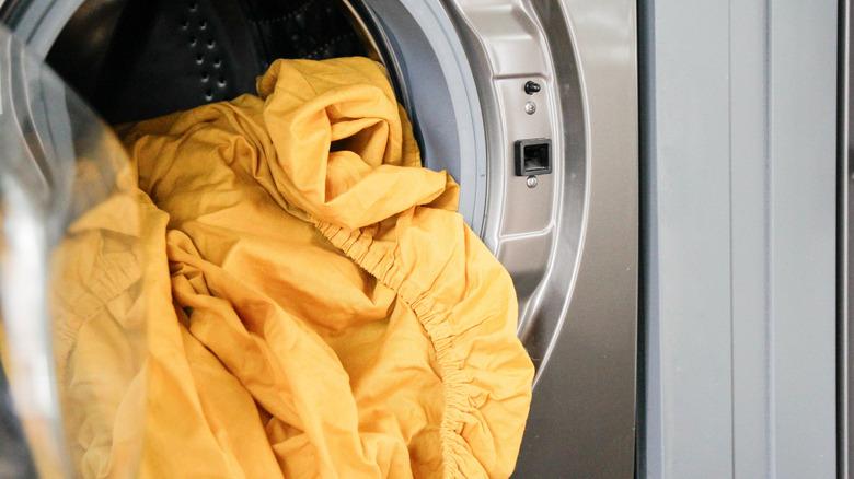 A fitted sheet in a front loading dryer