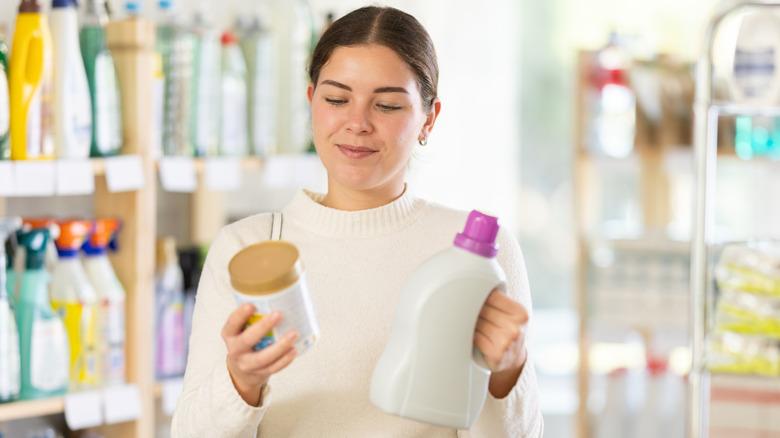 Woman reading laundry detergent labels