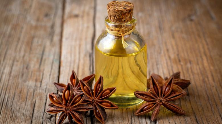 Essential oil in a bottle next to star anise