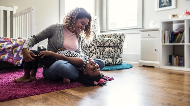 Mother and daughter playing on the floor