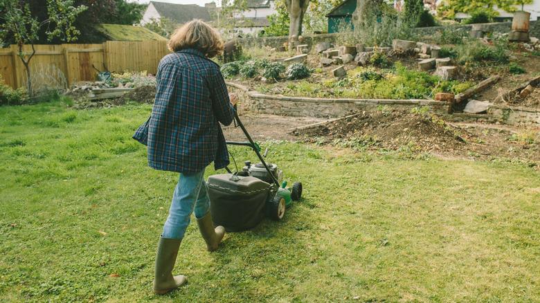 Woman mowing the lawn