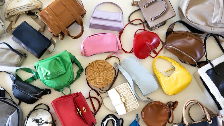 pile of various handbags on the floor