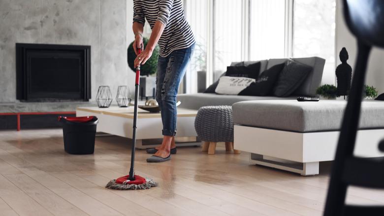 Woman damp mopping vinyl floors