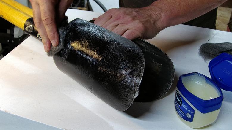 Protecting a post-hole digger from rust with Vaseline