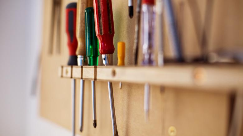 A variety of screwdrivers hanging in a workshop