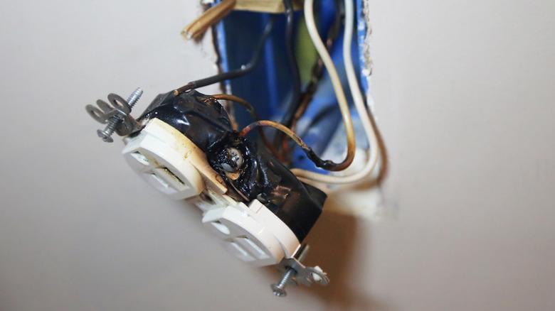 Burn marks and melting that indicate the receptacle has severely overheated