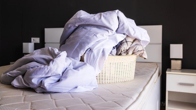 Comforter balled up in laundry basket to be washed
