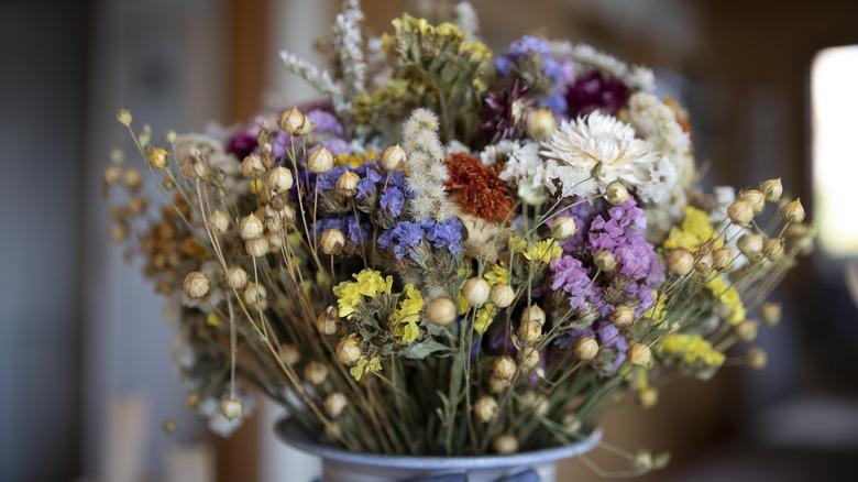 A close up of dried flowers in a vase.