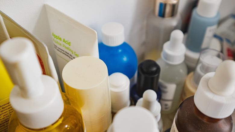 Assorted skincare in various bottles sitting on a shelf.