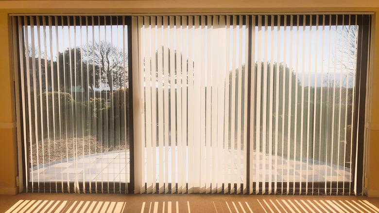 vertical blinds on a three-pane sliding door