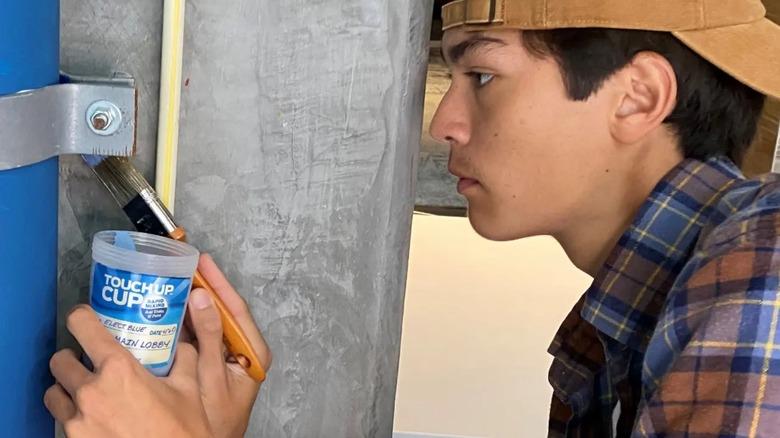 Boy doing paint work with Touch Up Cup