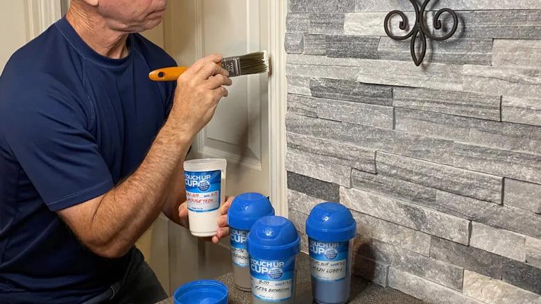 Man painting door frame with Touch Up Cup