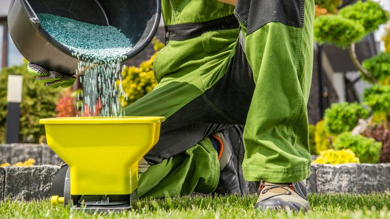 Adding granular fertilizer to a handheld broadcast spreader