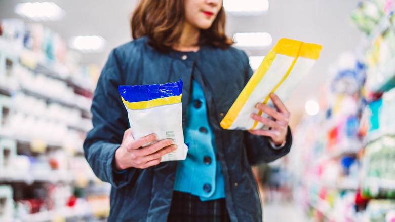 Woman looking at disinfectant wipe packages in store