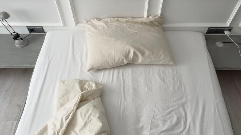 close up of unmade, messy bed and pillow